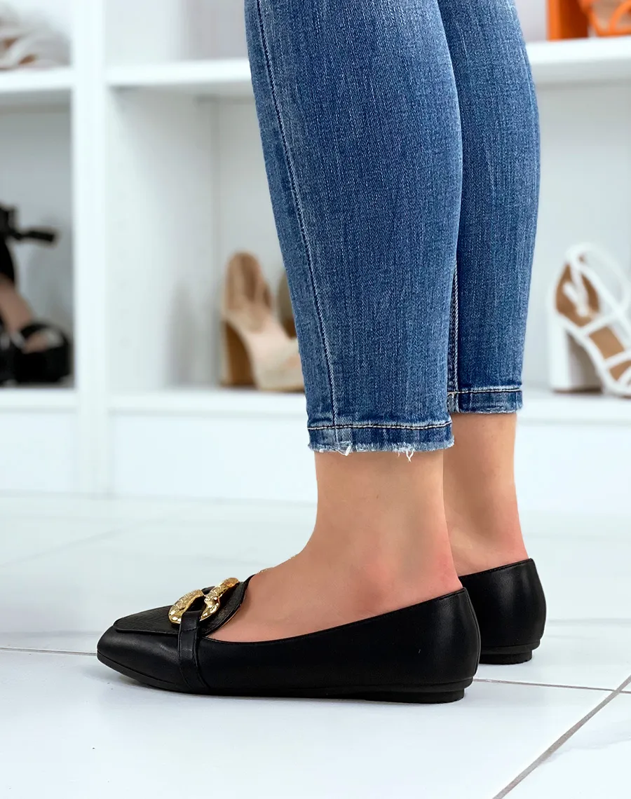 Black loafers with large imposing golden buckle.